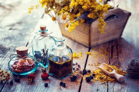 Fľaška tinktury malavit a suché zdravé byliny dřevěná lopatka léčivých bylinek